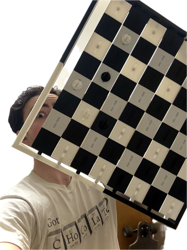 Sebastian Esteva holding up the tilted Poser Chess Set panel