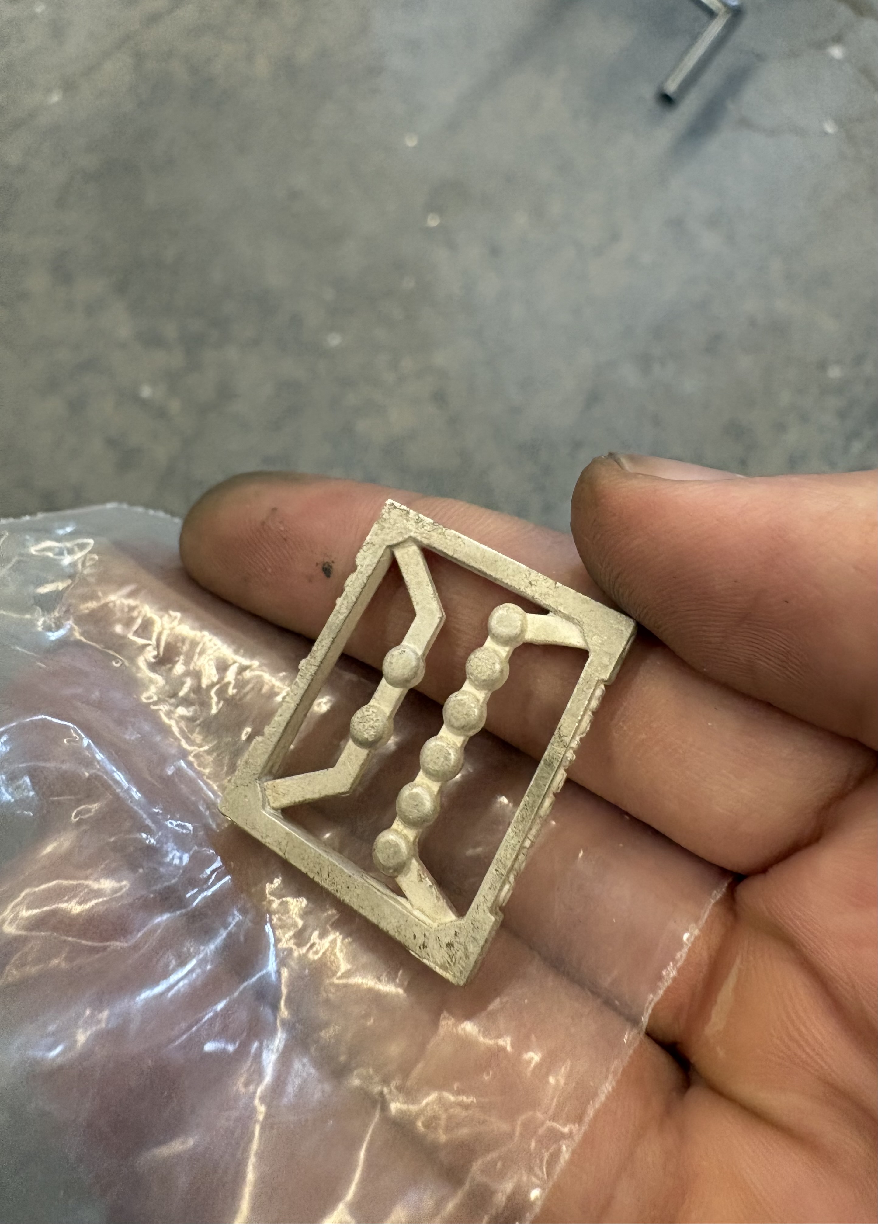 Raw cast silver pendant straight out of the investment mold, before finishing